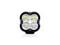 Front view of the lamp face showing the lens and central light source, with the housing and bezel clearly visible.