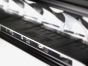 Detailed close-up image of the lamp showcasing key design features such as the lens, housing material, cooling fins, mounting bracket, and branding elements.